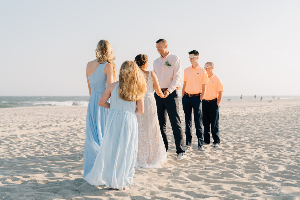 Bridal party during wedding ceremony on Cape May Beach