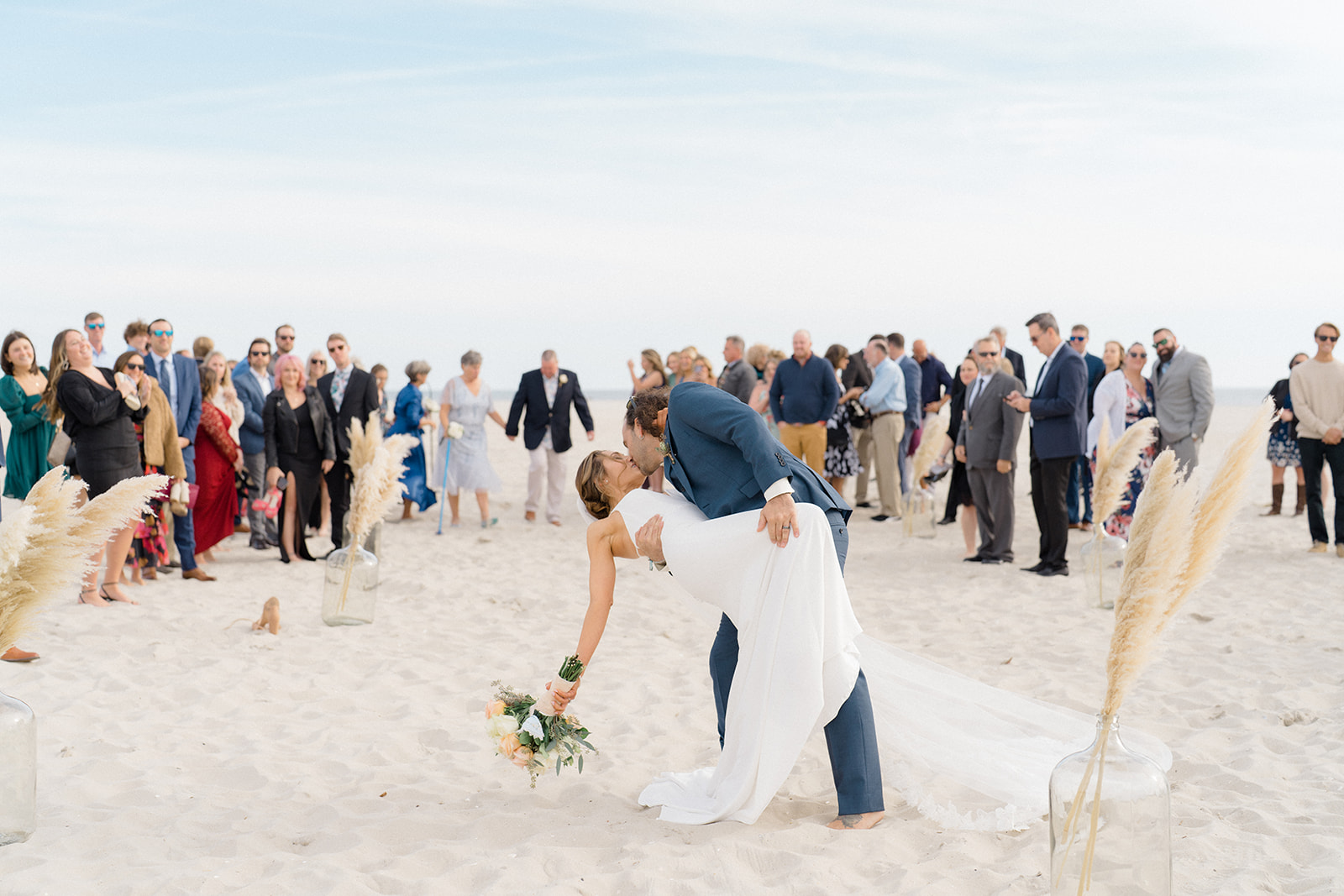 Bride and groom kiss after beach ceremony