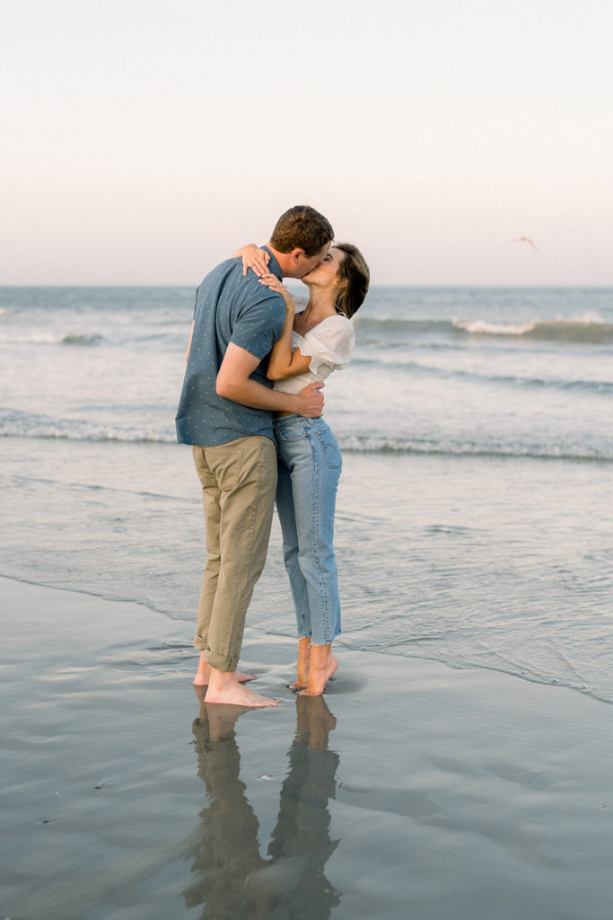 Couple kissing on the beach during their engagement session