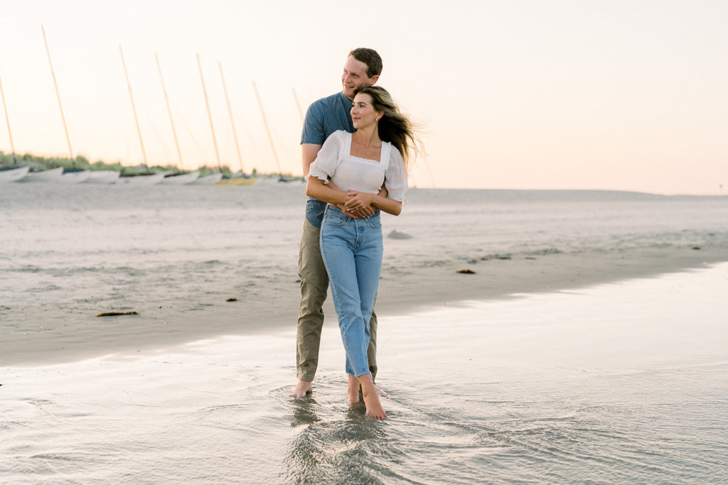 Couple hugging on the beach during their engagement session