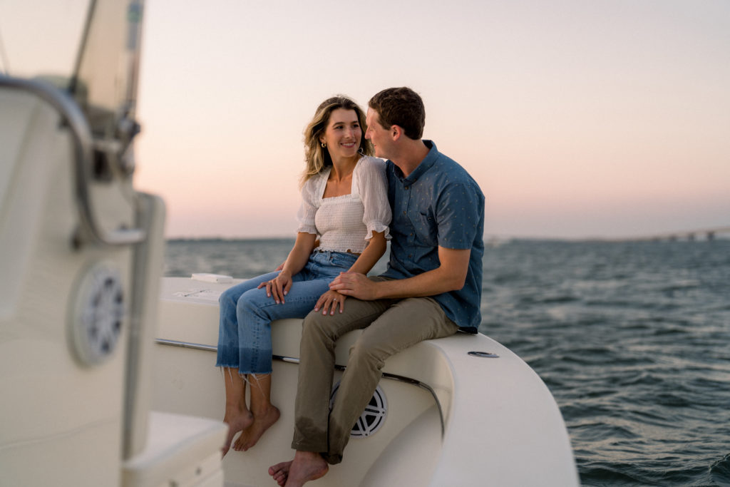 Couple on sunset boat ride for engagement session