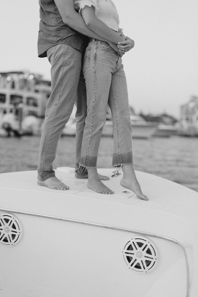 Couple on boat during romantic engagement session in Ocean City, New Jersey