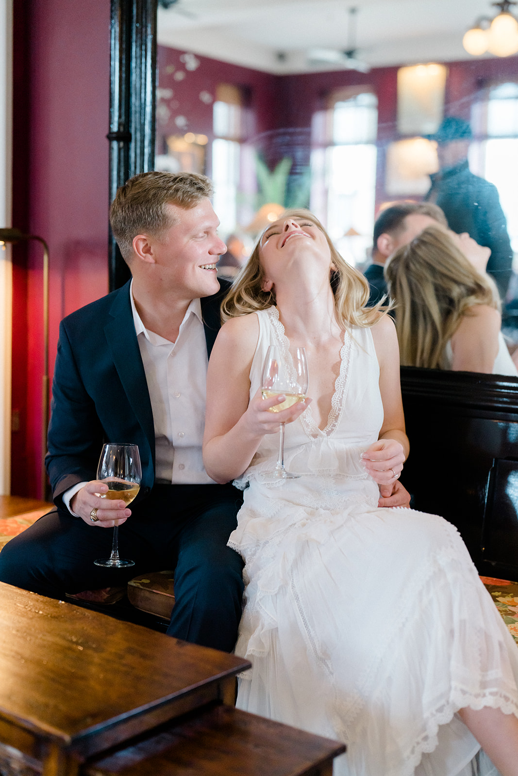 Newly engaged couple laughing and drinking wine in Congress Hall, Cape May, New Jersey