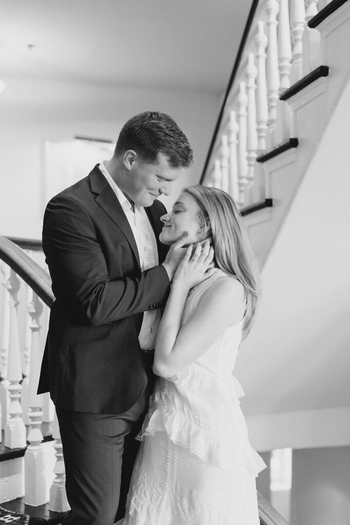 Newly engaged couple hugging and kissing at Congress Hall in Cape May, New Jersey for their charming engagement session
