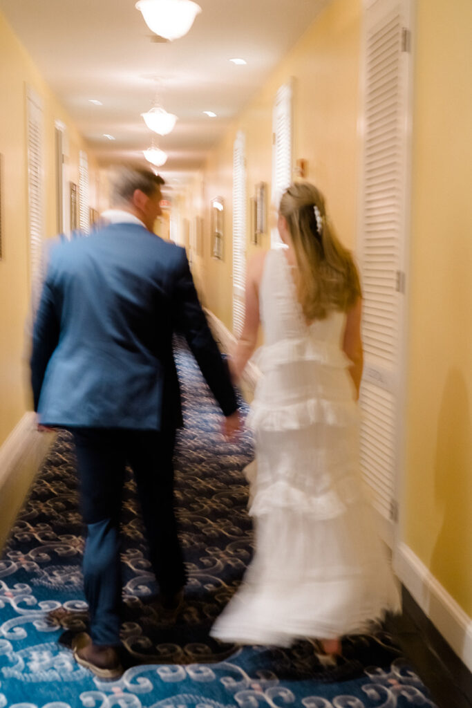 Newly engaged couple walking in the hallway of Congress Hall in Cape May, New Jersey for their charming engagement session