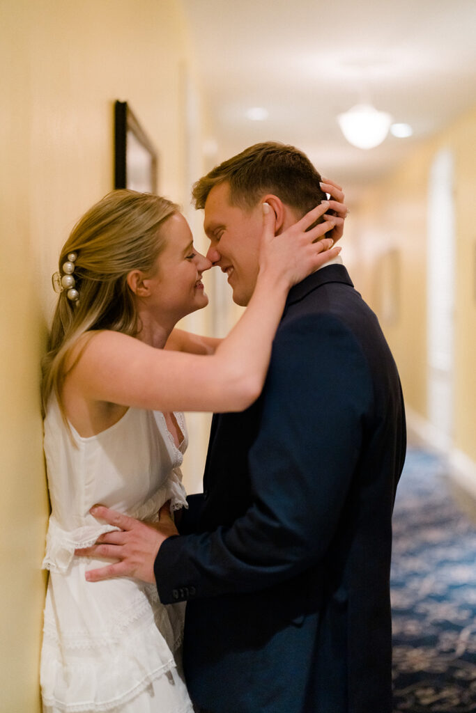 Newly engaged couple kissing in the hallway of Congress Hall in Cape May, New Jersey for their charming engagement session