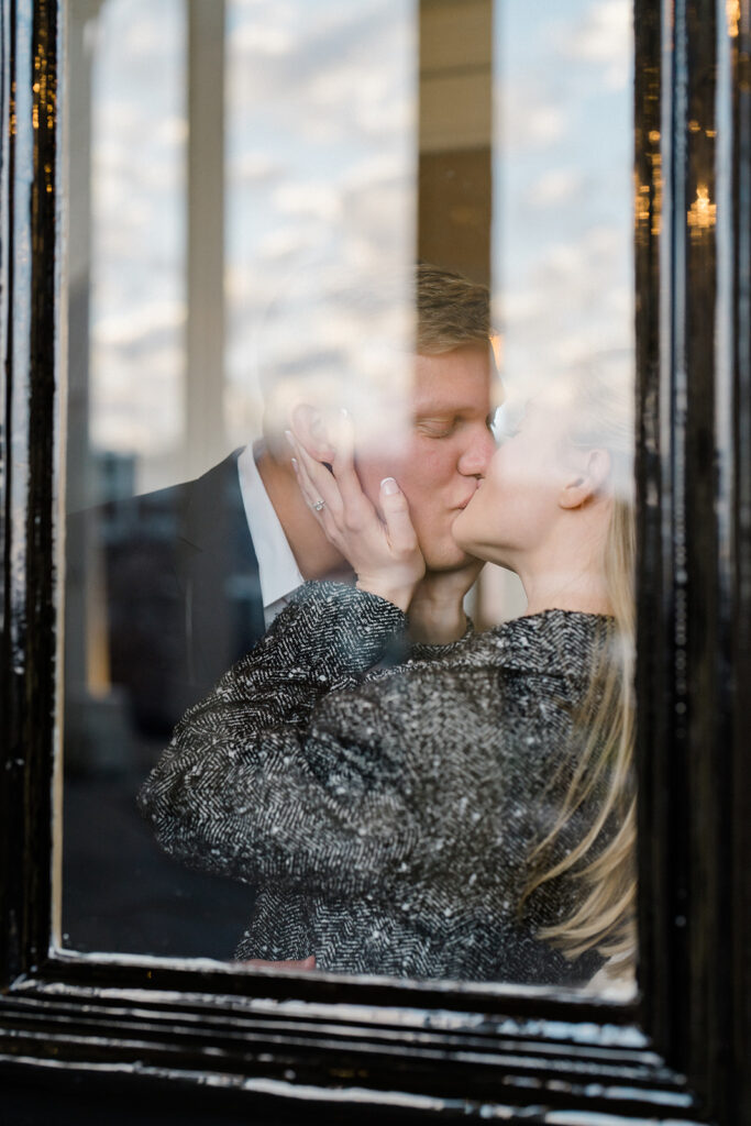Newly engaged couple kissing in the vestibule of Congress Hall in Cape May, New Jersey for their charming engagement session