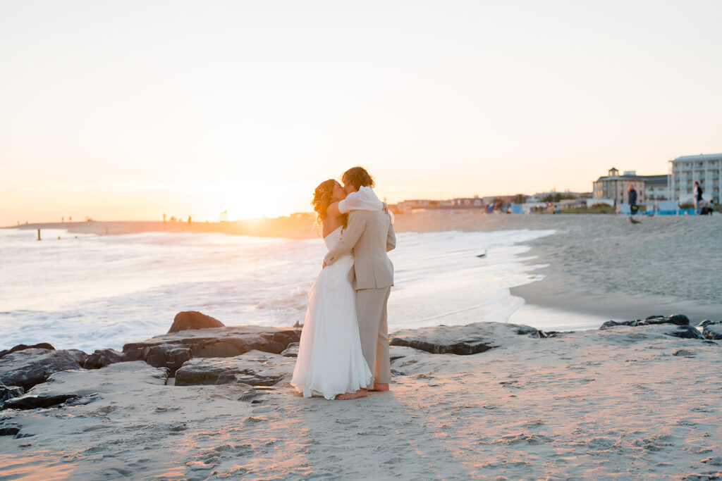 Bride and groom kiss on beach in Cape May, New Jersey