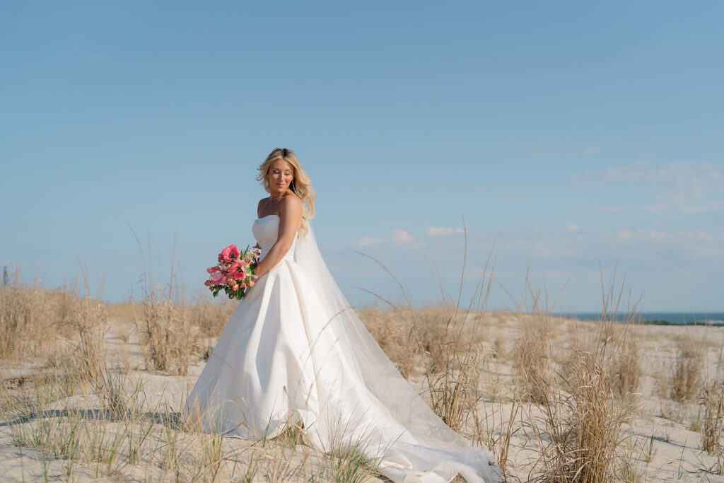 Bride in a Stella York wedding gown on the sand at Cape May beach